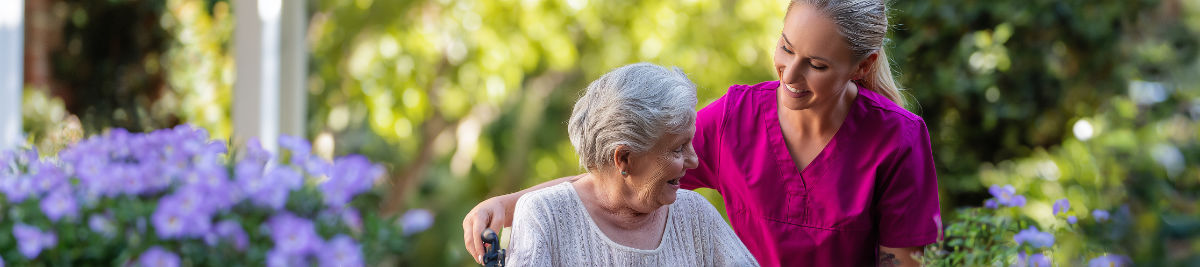 Alzheimer’s caregiver helping elderly woman at home in Highland Park Texas