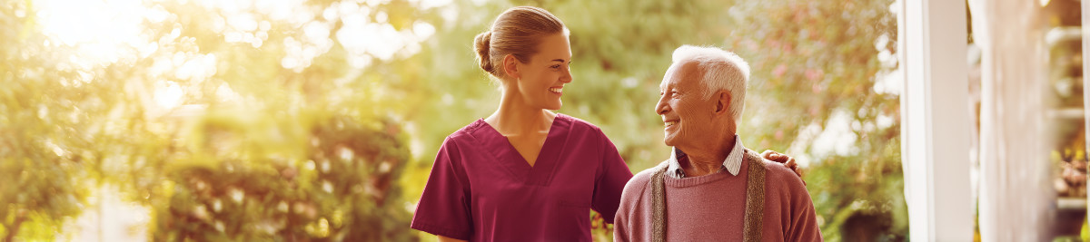 Senior man being assisted with meals and daily routines by live-in caregiver in Dallas