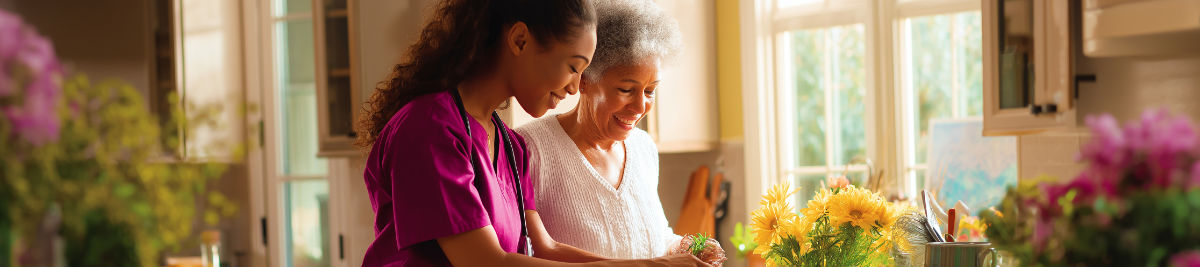 Caregiver helping senior woman with meal preparation at home in Dallas TX